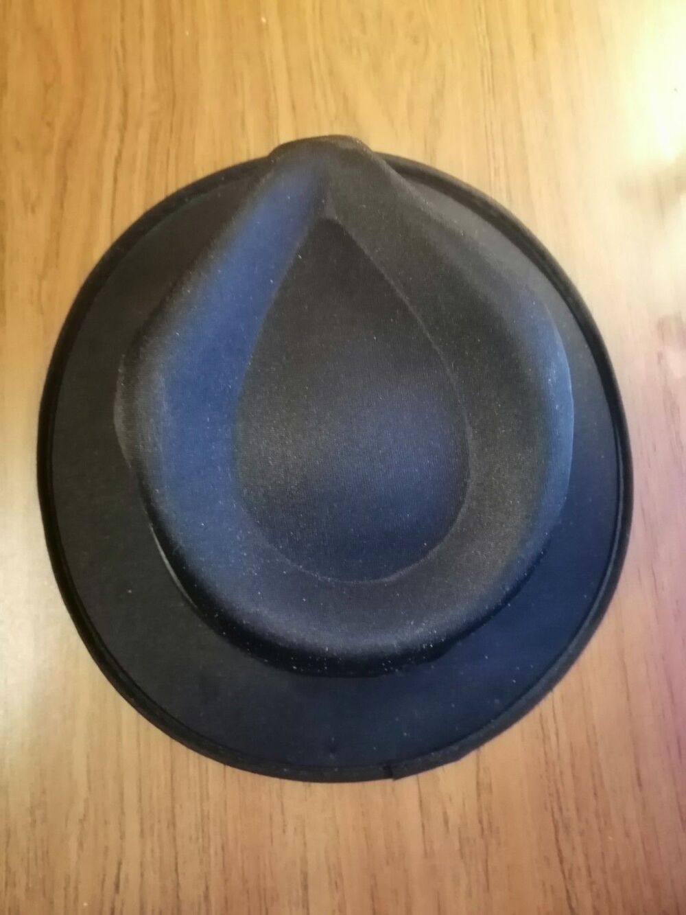 Black hat with pointed, indented crown, sides.  Has band. Spirit brand.